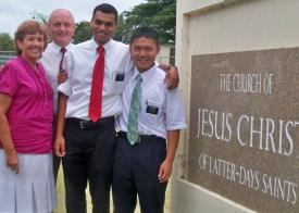 Helen Pitman (from left) Fred Pitman, Kegasi Turbovski, and Team Moua stand by the church sign on Cathreine's Rest Road.