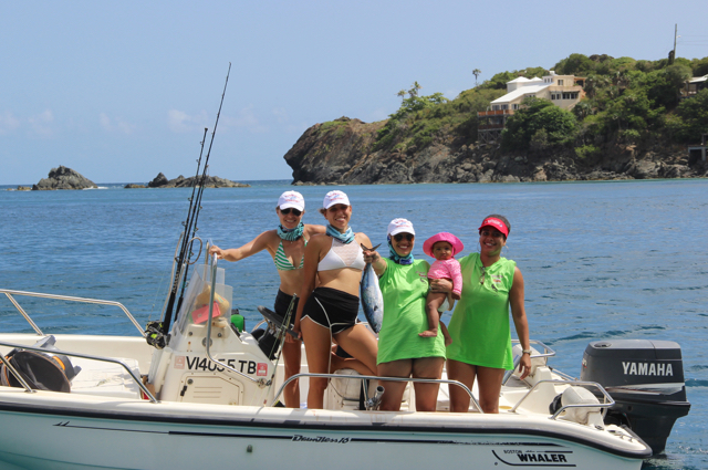 An all-female boat of participants in the tournament proudly displays its catch.