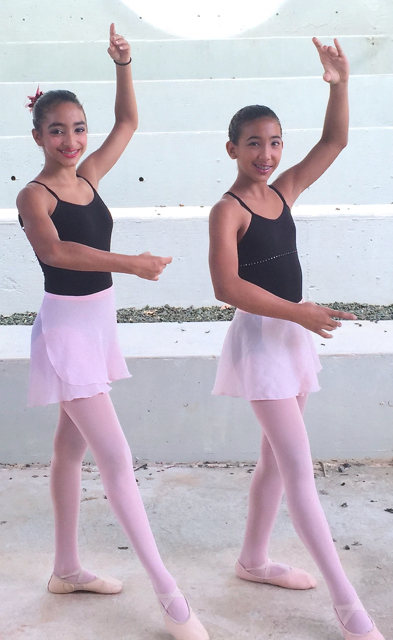 Marissa Bornn and Maia Aqui demonstrate tendu croisé devant (stretch or point crossed to the front). (Photo provided by V.I. Montessori School and Peter Gruber International Academy)