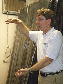 Edward Mackenzie explains the solar water heating system at the Solar Systems LLC opening.
