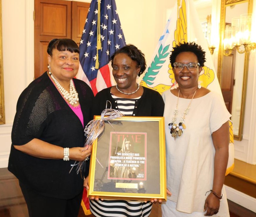 Education Commissioner Sharon Ann McCollum gives Dinah Browne (center) a tribute for being the State Teacher of the Year 2017