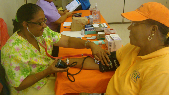 Nurse Dutchelle Drummond takes Maud Phillips' blood pressure during Wednesday's Health Fair.