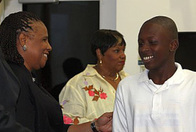 Deshoy Liburd (right) accepts his certificate from Insular Superintendent Jeanette Smith-Barry.