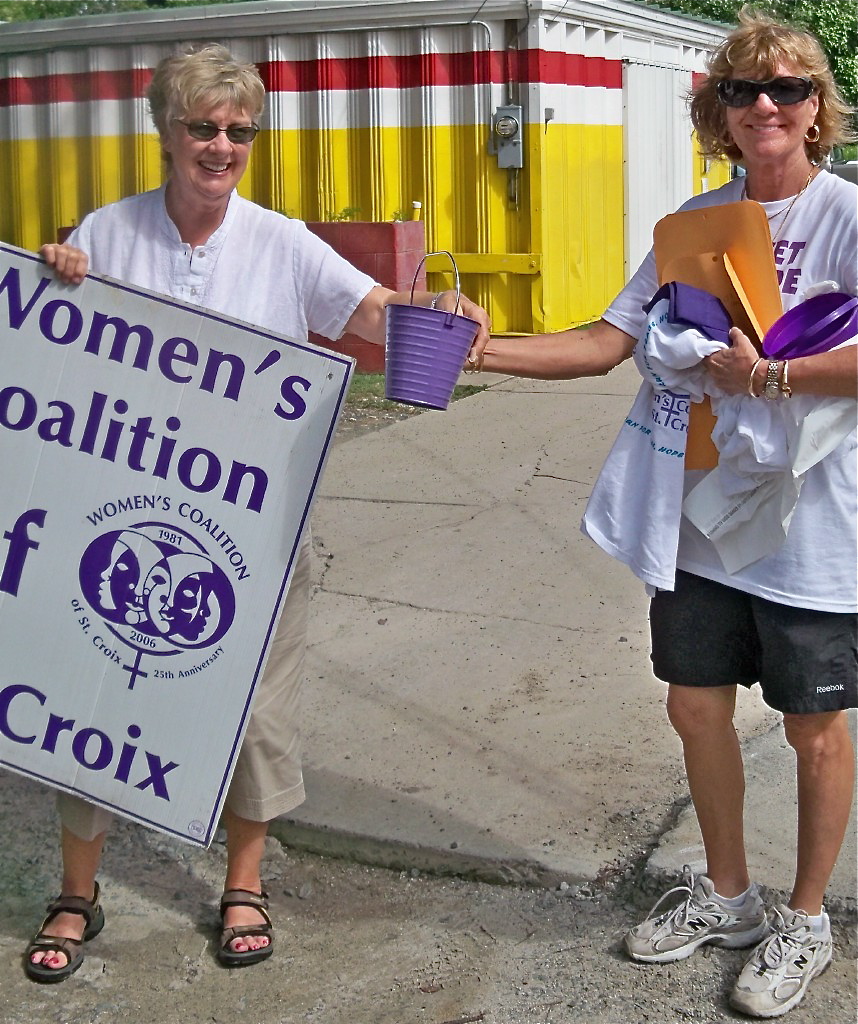 Volunteer Nancy Ayer, left, and Women's Coalition Co-Director Mary Mingus give out buckets to volunteers.