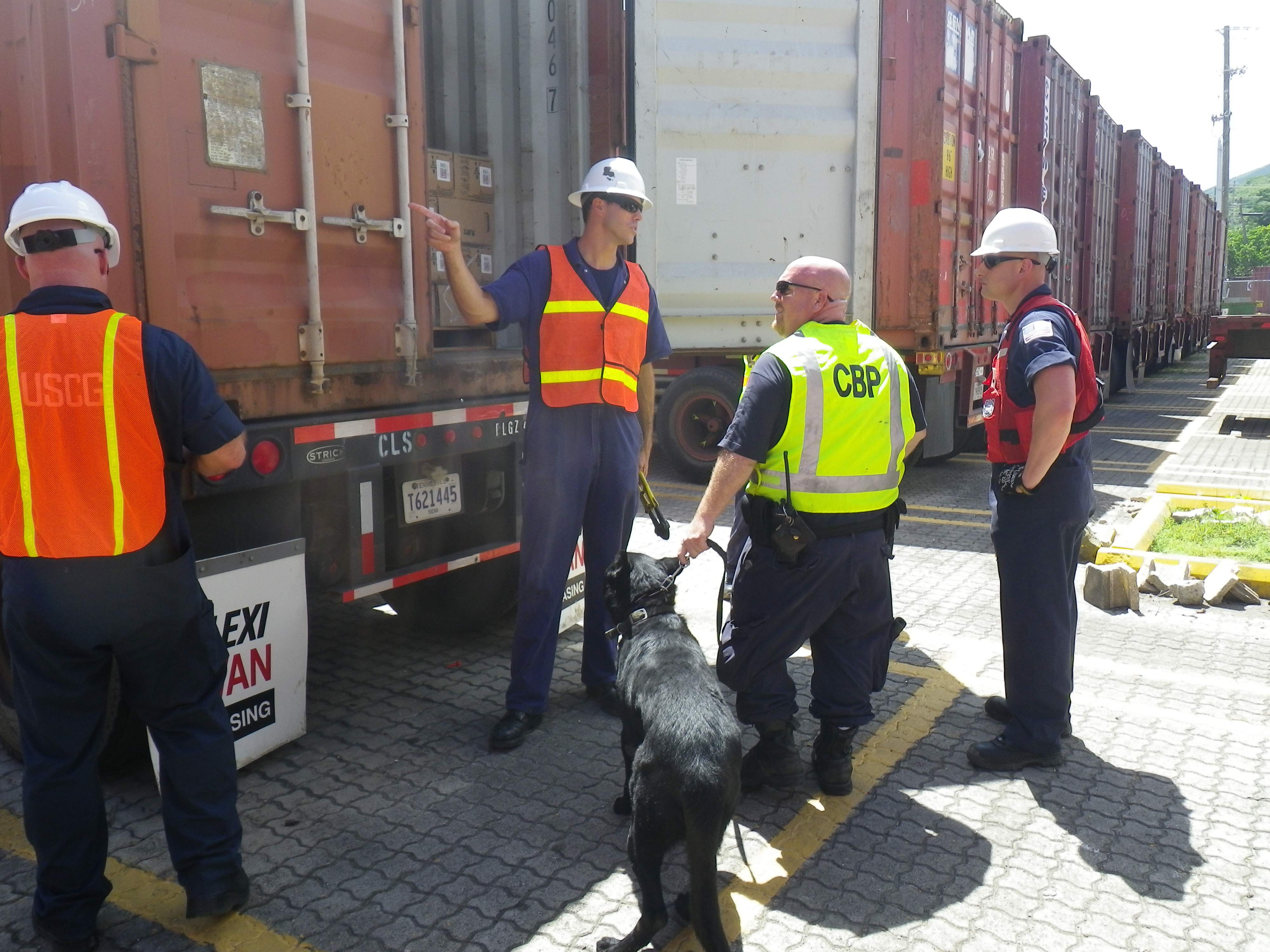 Coast Guard and Customs and Border Protection personnel check the contents of a container at the Crowley Marine Terminal Saturday at St. Thomas harbor. (Photo courtesy USCG)