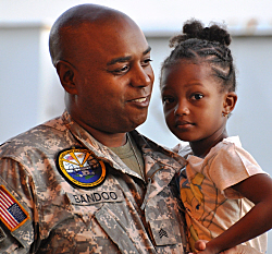 Sgt. Peter Bandoo holds his daughter Ariana before heading off to Iraq.