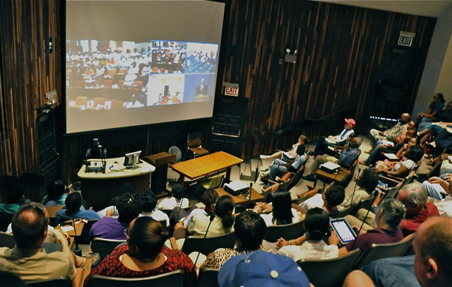 Faculty and staff on the St. Croix campus watch the convocation on the videoconferencing system. 