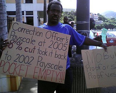 Corrections Officer Lindford Warner joins in a protest held Wednesday outside the Alexander Farrelly Criminal Justice Complex on St. Thomas.