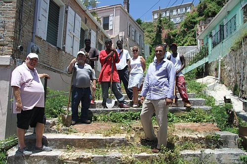 Members of My Brother's Workshop and officials from the St. Thomas Historical Trust break ground Wednesday on the first step street restoration project. (Photo Scott Bradley).