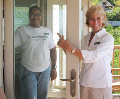 Celia Anthony, left, of the housekeeping department meets Concordia and Maho vice-president Maggie Day at the door.