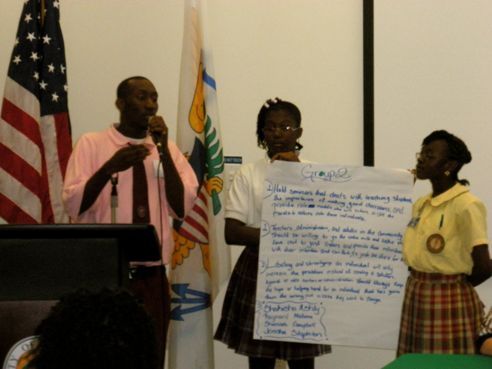 Students Raynord Malone, Sheniah Campbell and Jenishe Stapleton present dropout-prevention solutions to Tuesday's audience.
