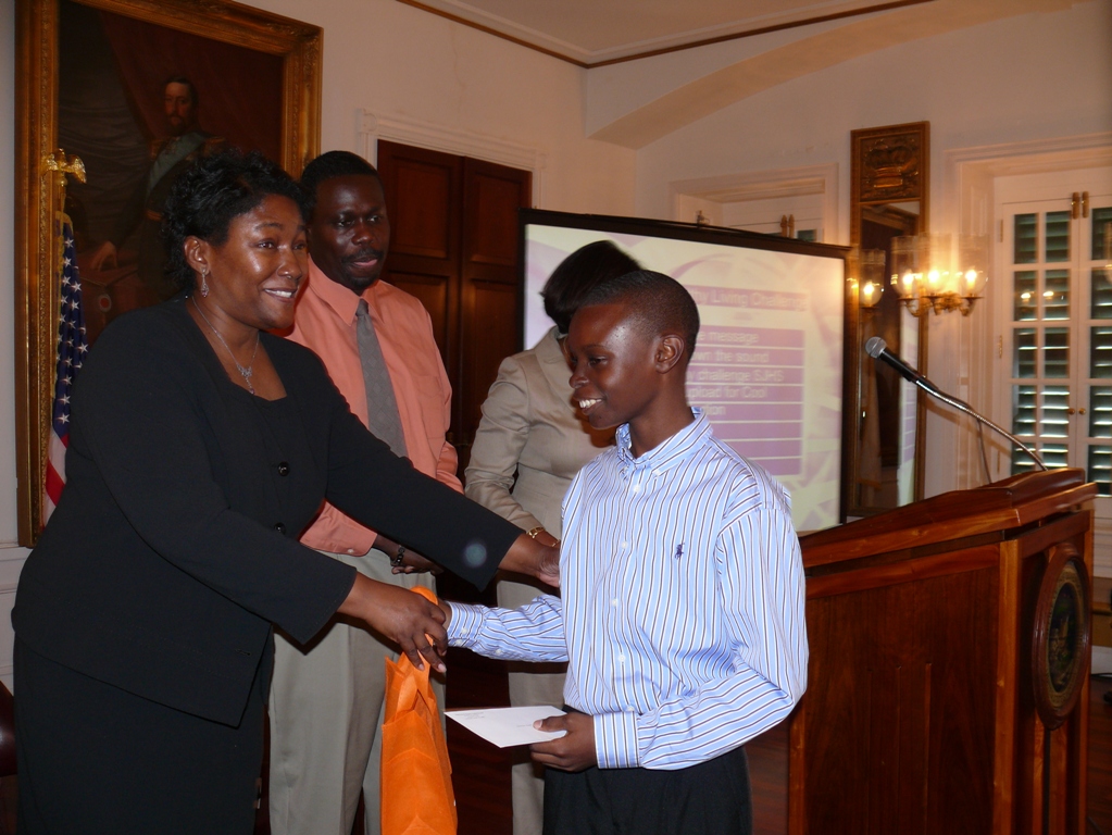 Education Commissioner LaVerne Terry congratulates Shaquille Thomas of the St. Croix Central High video contest team.