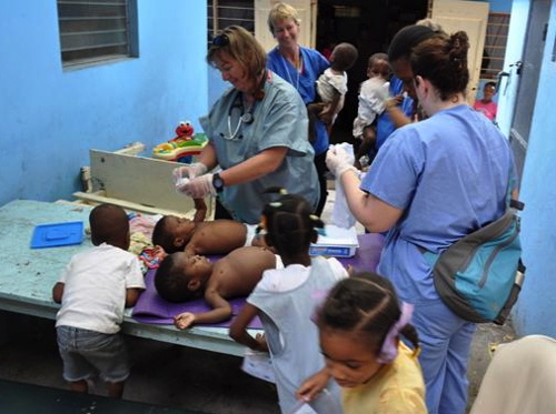 Volunteer nurses tend to orphans in Haiti. Photo by Carmen Partidge.