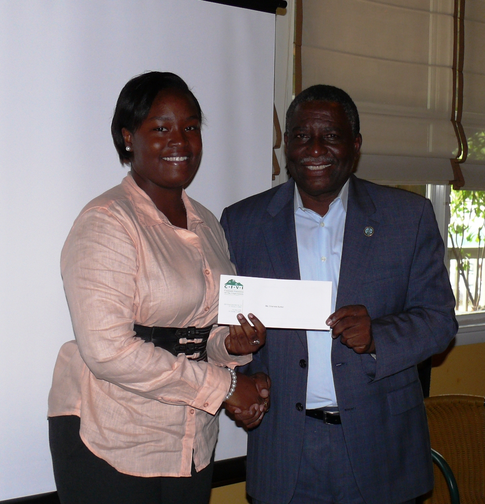 Charnele Burton receives a CFVI check from the Artrelle M. Wheatley Scholarship Fund at Tuesday's scholarship ceremony on St. Croix.