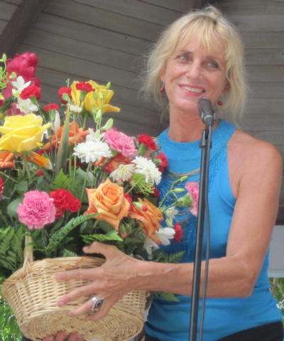 Emily 'Lolita' Bratton accepts a flower arrangement in honor of her years of service to the island's arts and crafts scene.