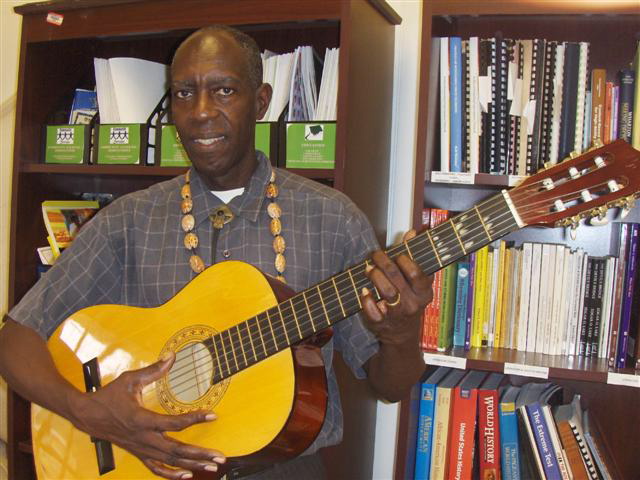 Glen 'Kwabena' Davis sings as he plays his ever-present guitar.