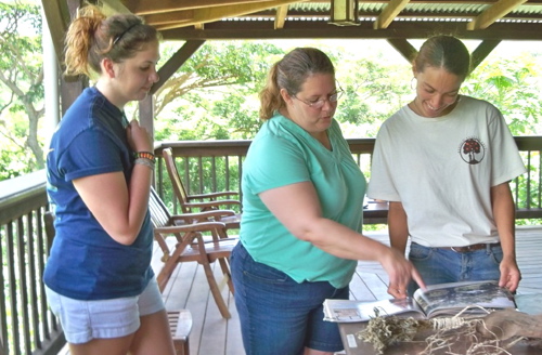 From left, Jackie Russell and Raquel Ruiz Castanada identify trees with instructor Shelli Brin.