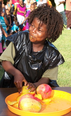 Trelot Tafari munches a mouthful of mango in the 2010 mango-eating contest. (Carol Buchanan photo)