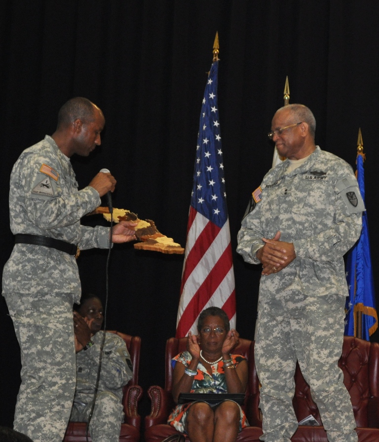 Brig. Gen. Timothy L. Lake presents a plaque to Adj. Gen. Renaldo Rivera for the outstanding job that that VING members did while deployed.