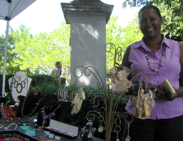 Sylvia Brady shows off her 'Island Angels' during the Starving Artist Sale at the Whim Museum.