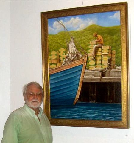 Ray Miles stands before one of his island paintings.