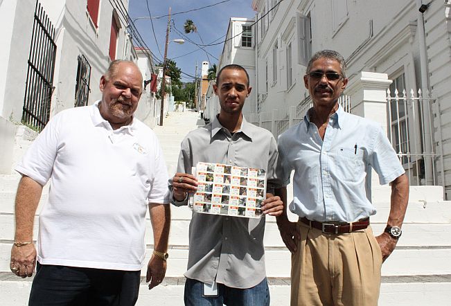 Ronnie Lockhart, Pedrito Francois from V.I. Lottery and Trevor Milner (pictured from left) unveil the new ticket collection on the steps of Lille Taarne Gade. 