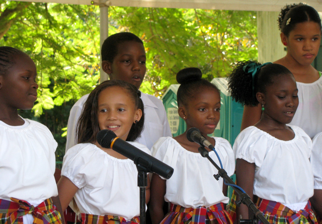 The Junior Poinsettias from Evelyn Williams School sing Sunday during the Starving Artist Sale at the Whim Museum.