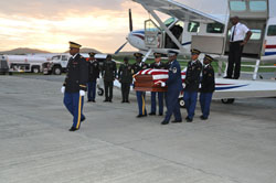 Chaplain Dion Christopher leads guardsmen with the remains of former Lt. Gov. Derek Hodge.