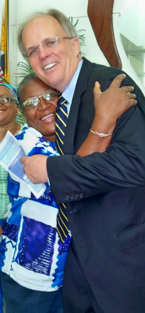 Magdelene Hobson, president of the Retired Nurses of St. Croix, gets a big hug from hospital CEO Jeff Nelson.