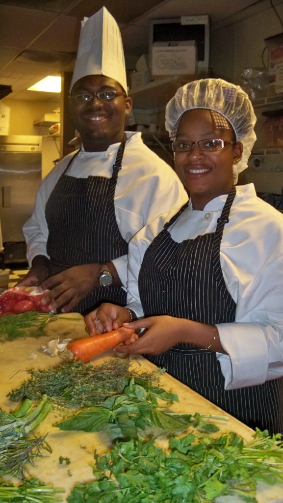 Young chefs Careeme Smith (left) and Khadijah Carr were all smiles Wednesday as they prepped vegetables for the competition.