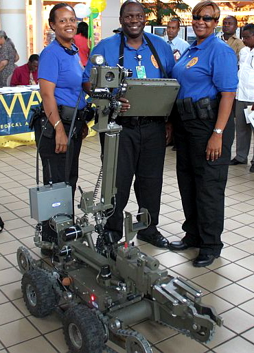 Members of the VIPD's Hazardous Devices Unit display the Andros robot, which can remove all types of explosive devices. 