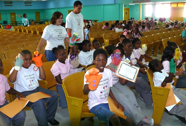 Students from Alfredo Andrews After School Program show off their hand-made puppets Thursday after putting on a series of puppet shows on kindness to animals.