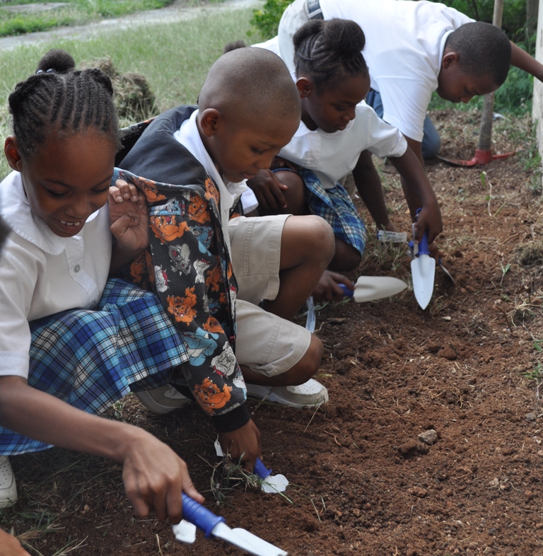 Students from Claude O. Markoe Elementary get ready to plant spinach in the school’s first garden bed.
