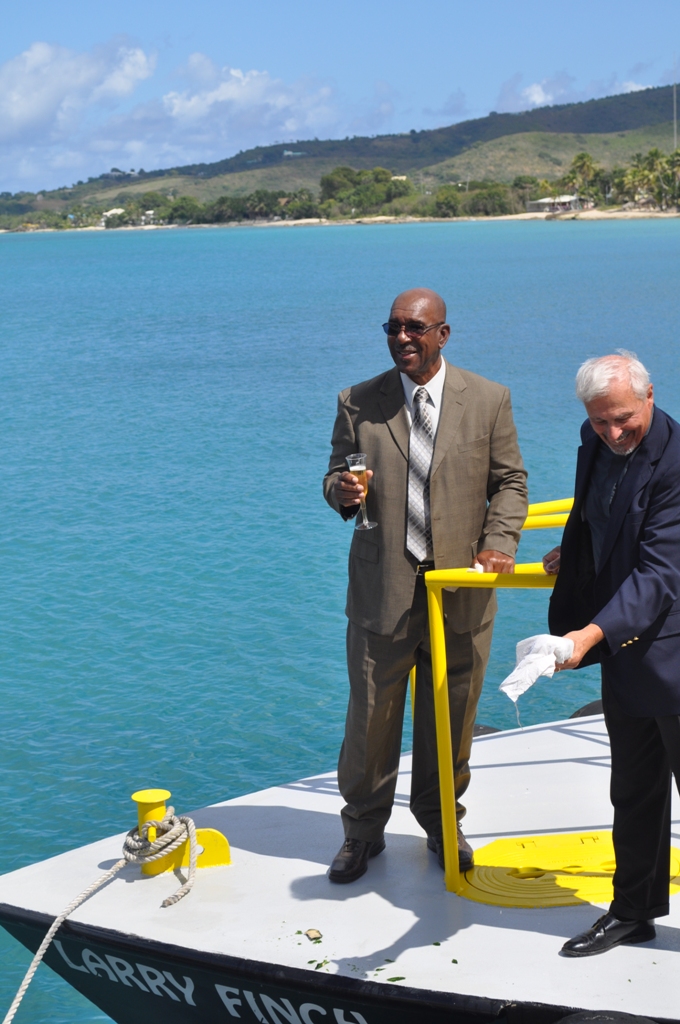 Earl "Larry" Finch (left) standing with Pastor Robert Dendtler, who christened VIPA's newest pilot boat in Finch's honor.