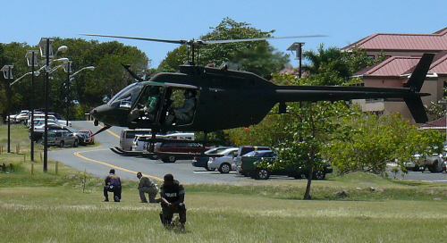 An OH-58 "Kiowa" helicopter prepares to touch down Friday near the UVI campus.