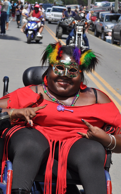 Robbi Phillips parades alongside the LV LV Rockers float.