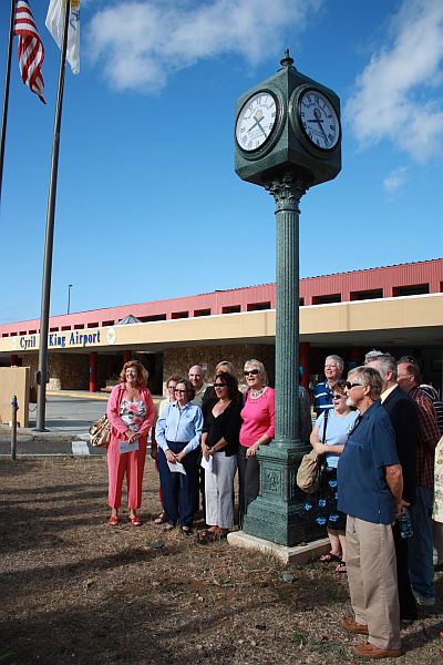 V.I. Rotarians gather at the St. Thomas airport Tuesday to unveil a clock they donated in commemoration of Rotary International's Centennial Celebration.
