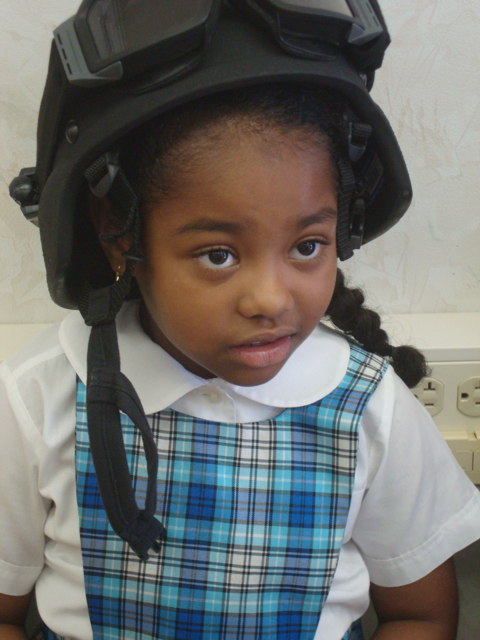 First-grader Samara Lammy tries on a police helmet.