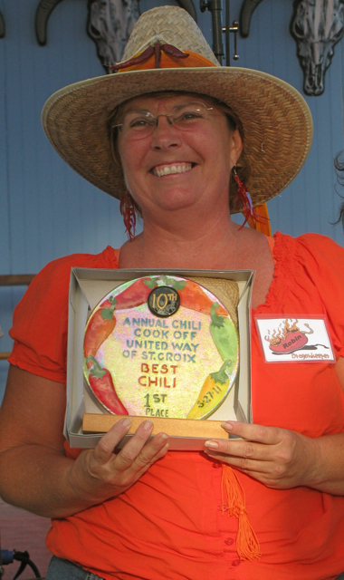 Robin Becker beams as she accepts her first-place award for her Dragon Breath chili at the 10th Annual Chili Cook-Off Sunday at Divi Carina Bay Beach Resort.