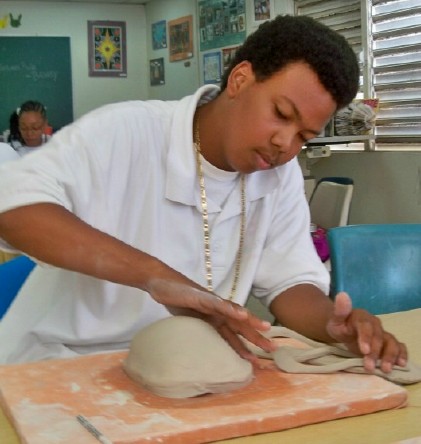 Tenth-grader Kadheem Henneman works on a likeness of Martin Luther King Jr. in clay.