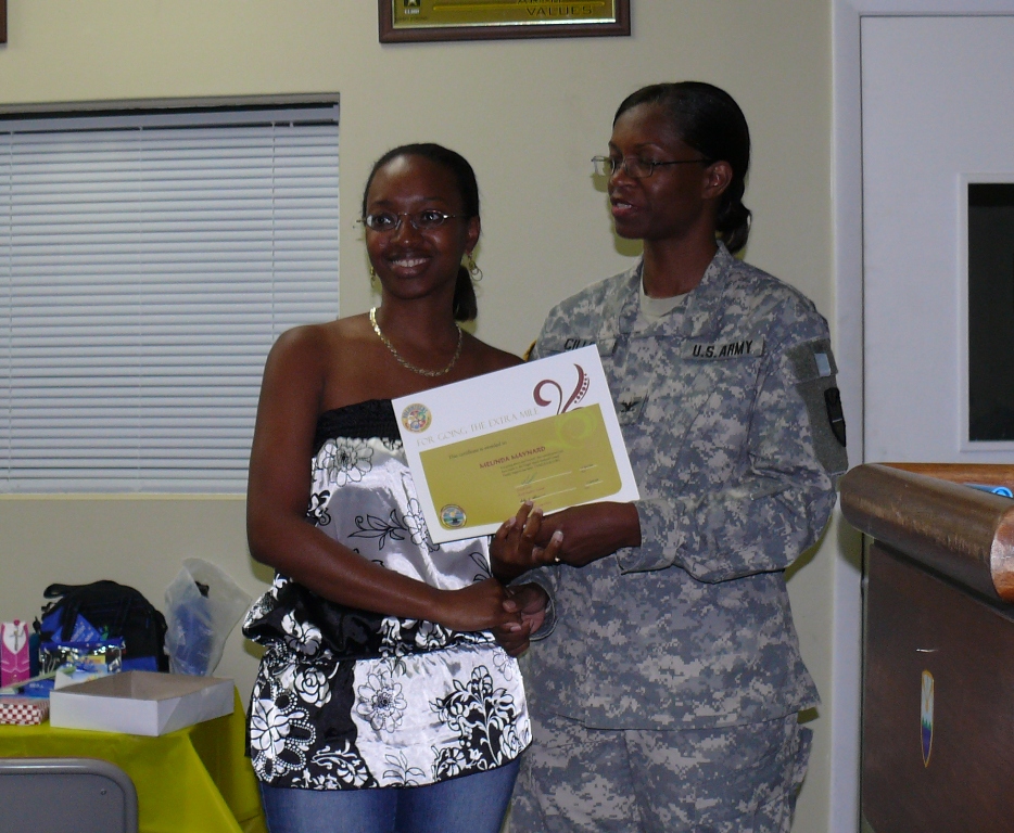 Volunteer Melinda Maynard receives a certificate of appreciation from VING Col. Linda Cills.