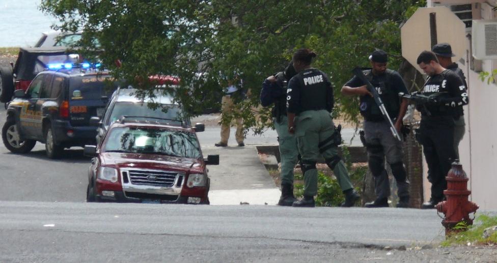 VIPD officers prepare to raid the Eagle Mini Mart in Frederiksted Monday.
