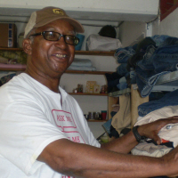 Larry Christian stocks shelves at the Red Cross store.