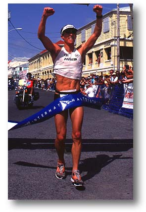 Past Iron Man 70.3 winner Jimmy Riccitello crosses the finish line. 