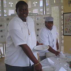 Melanious Charles (left) and Lenisha Browne set the table.
