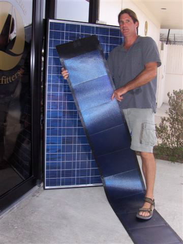 Robert Dinion displays a flexible, adhesive solar electric panel.