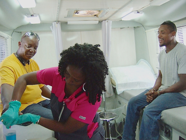 Henry James and Jean Washington prepare to donate blood with Nurse Latoya Martinez.