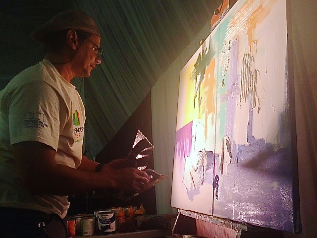 Artist Ensor Colon works on a piece during the gala that was auctioned during the event.