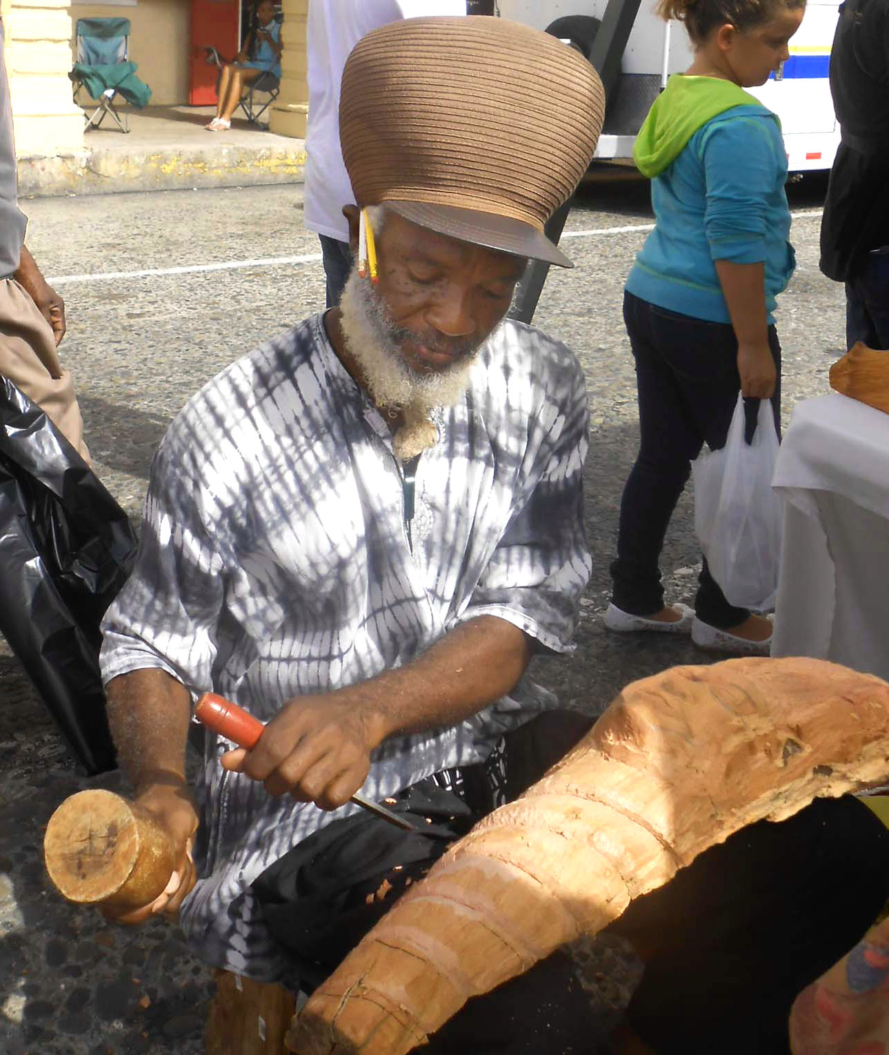 Woodworker, teacher and rummer Afreekan Southwell carves a creation at his booth at the Cultural Fair.