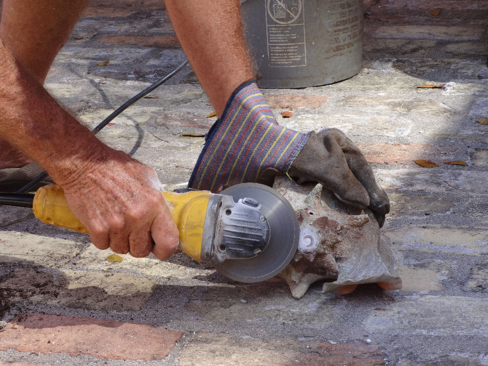 Cutting an embouchure at the tip of the conch. 